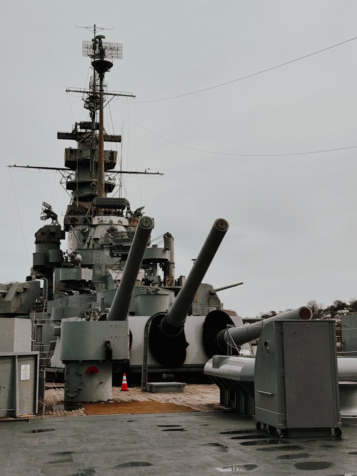 Home Historic USS Alabama battleship with visible artillery guns on deck.